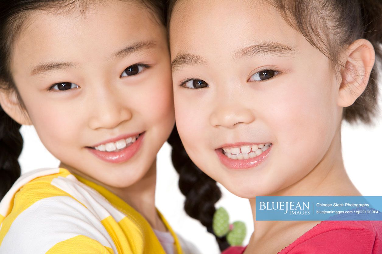 Two Chinese friends standing side by side, close up