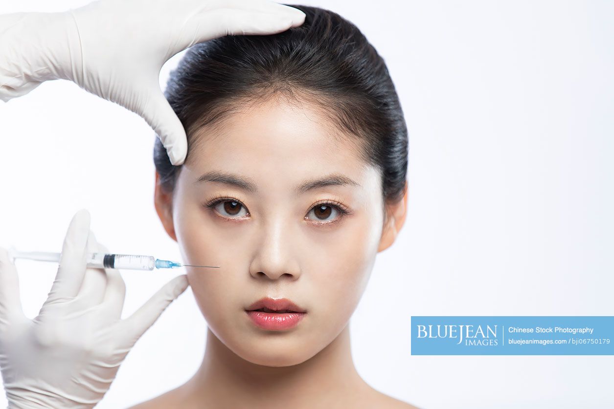 Young Chinese woman receiving Botox treatment