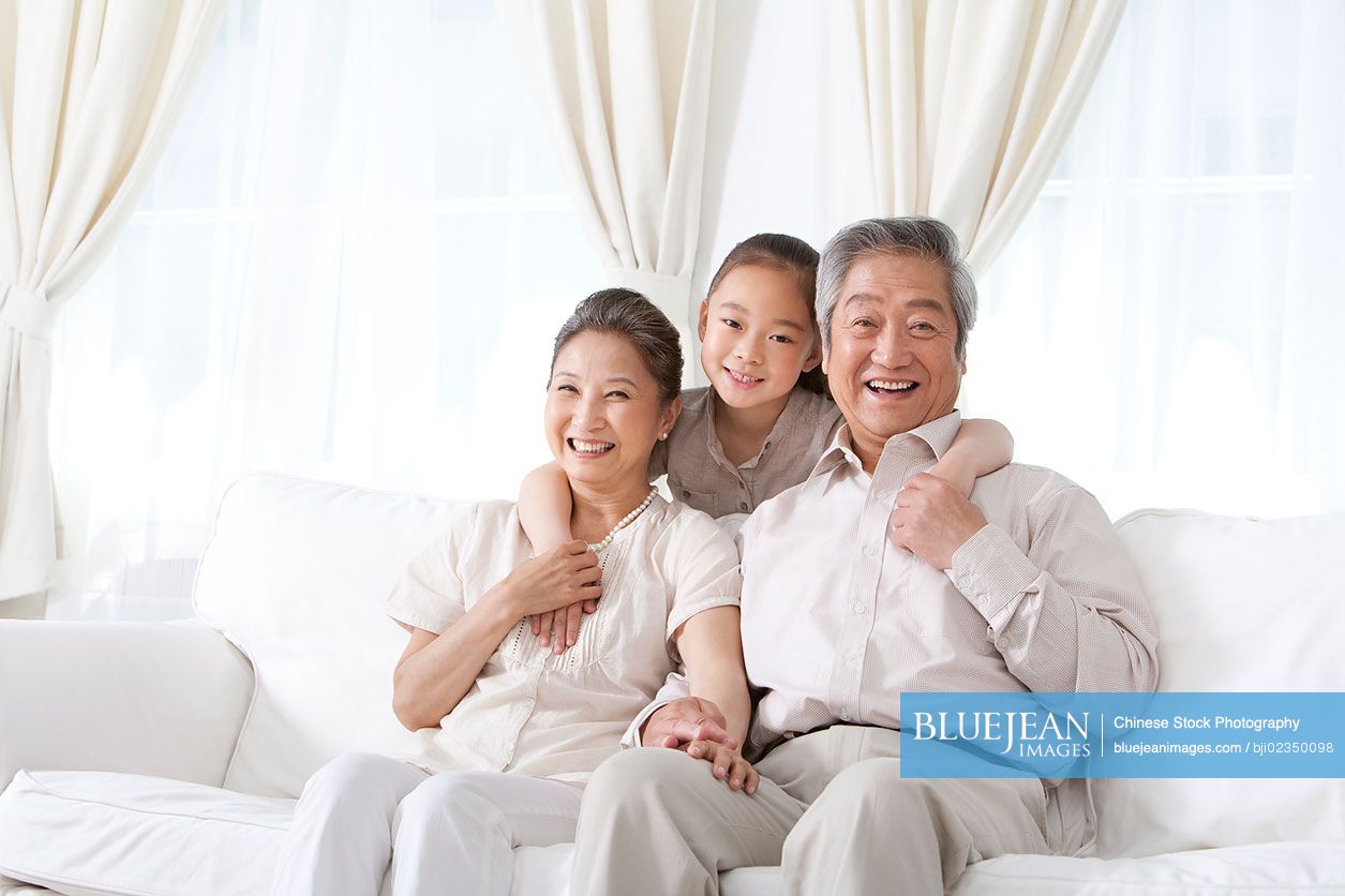 Happy Chinese grandparents with granddaughter