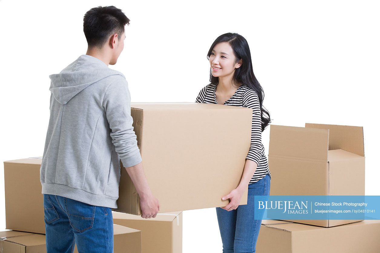 Young Chinese couple moving house