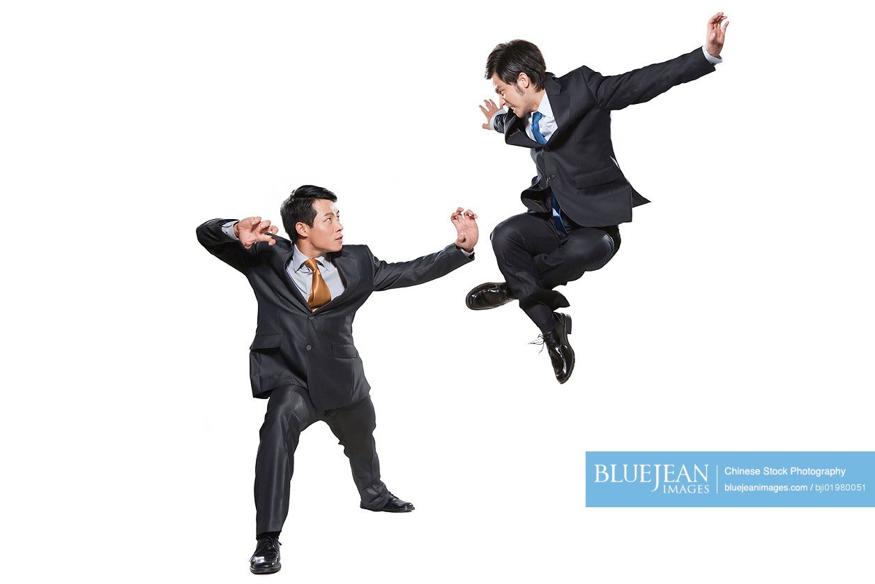 Two Chinese businessmen fighting on white background