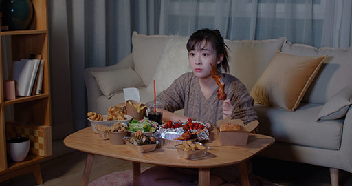 Young Chinese woman eating take-out food at night,4K