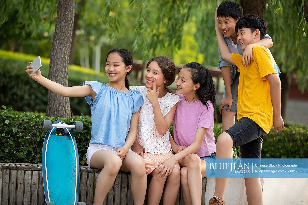 Teenagers taking selfie with smartphone