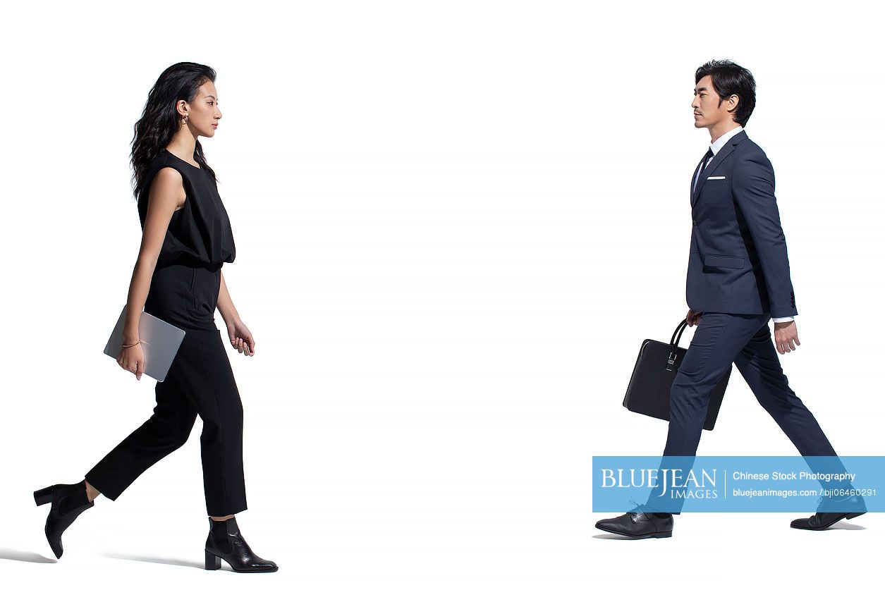 Confident Chinese business people walking