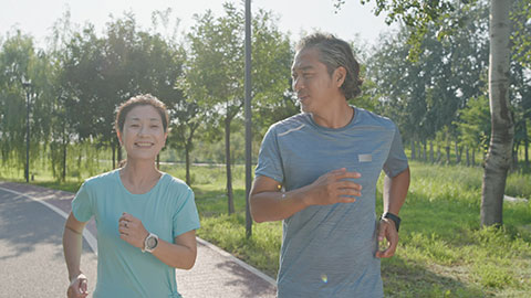 Happy mature Chinese couple running in park,4K