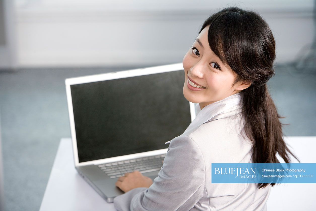 Chinese office worker at her desk