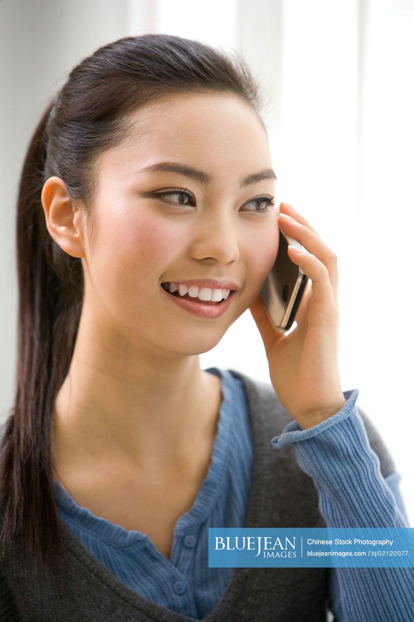 A young Chinese woman using mobile phone