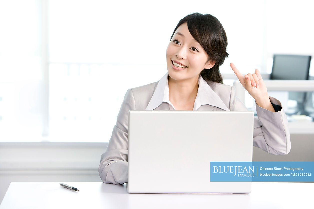Chinese office worker at her desk