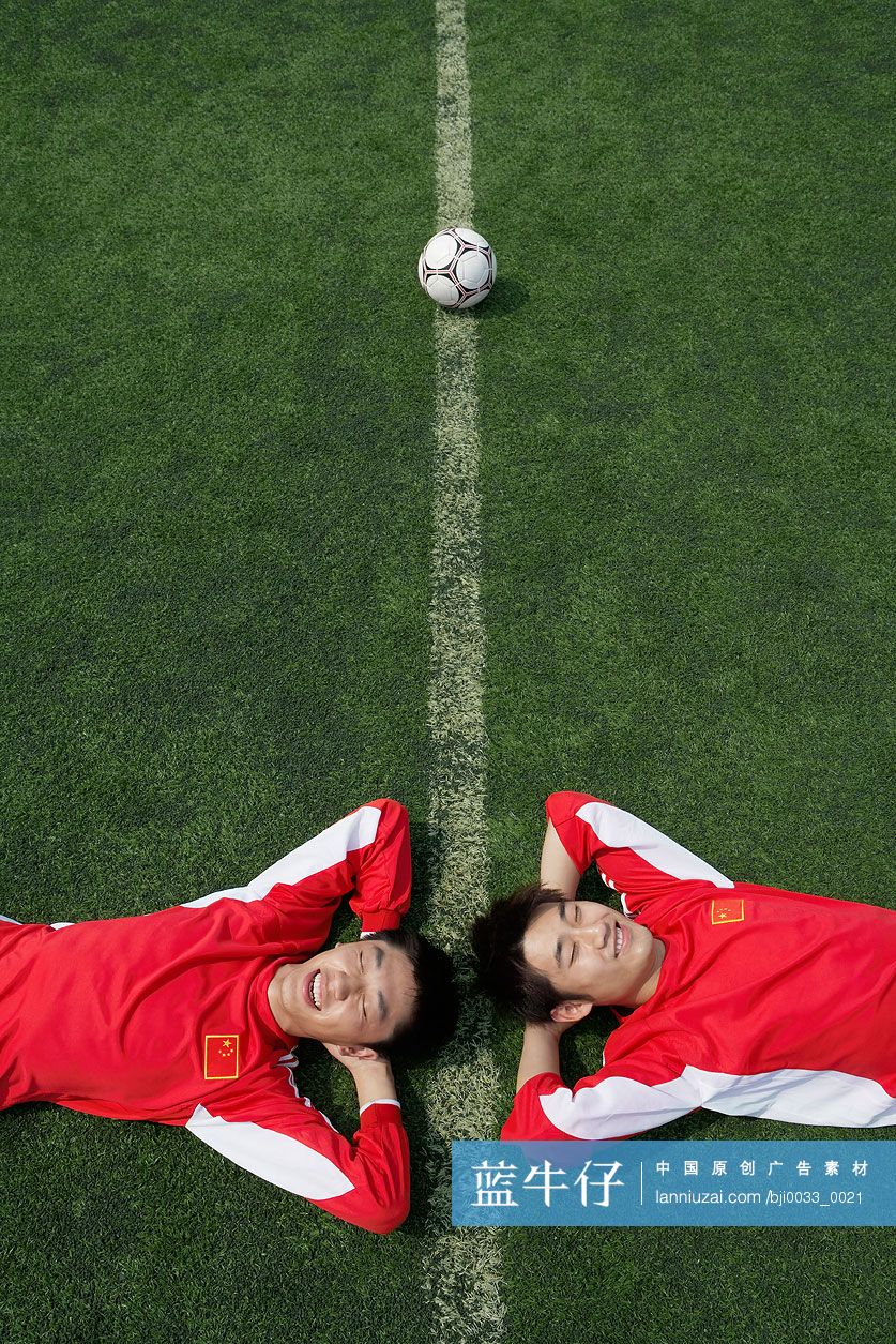 足球运动员躺在草地上