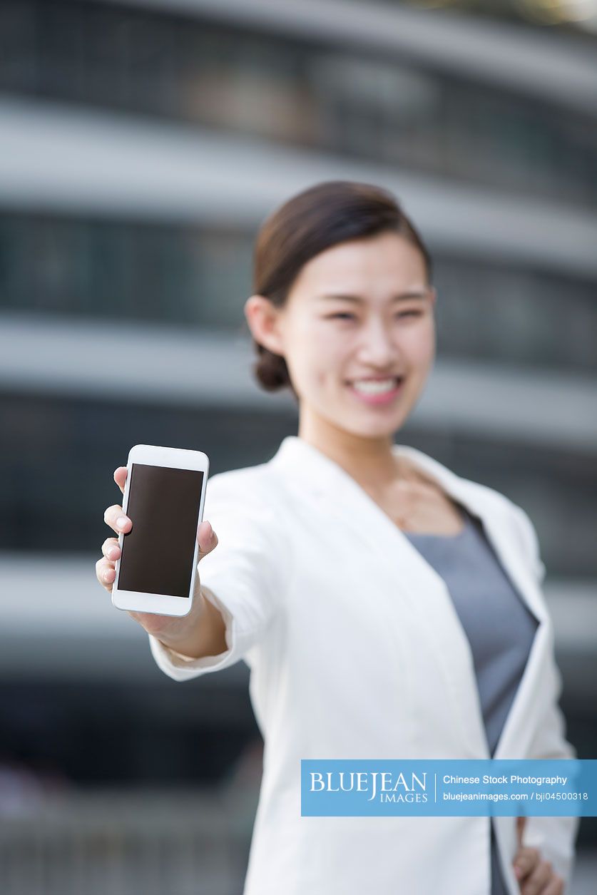 Chinese businesswoman showing smart phone