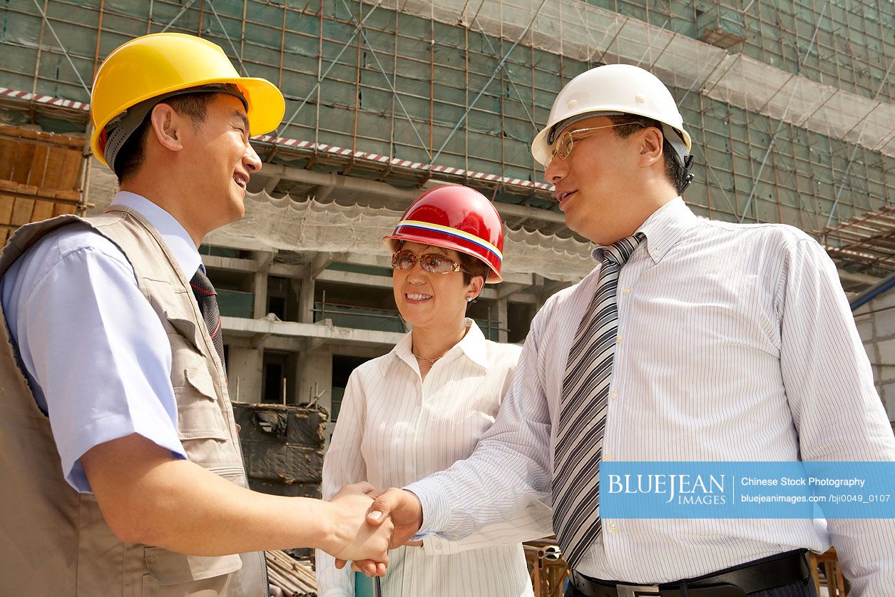 Chinese Construction Contractors Shaking Hands