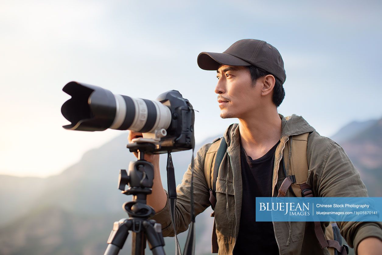 Chinese photographer taking photos outdoors