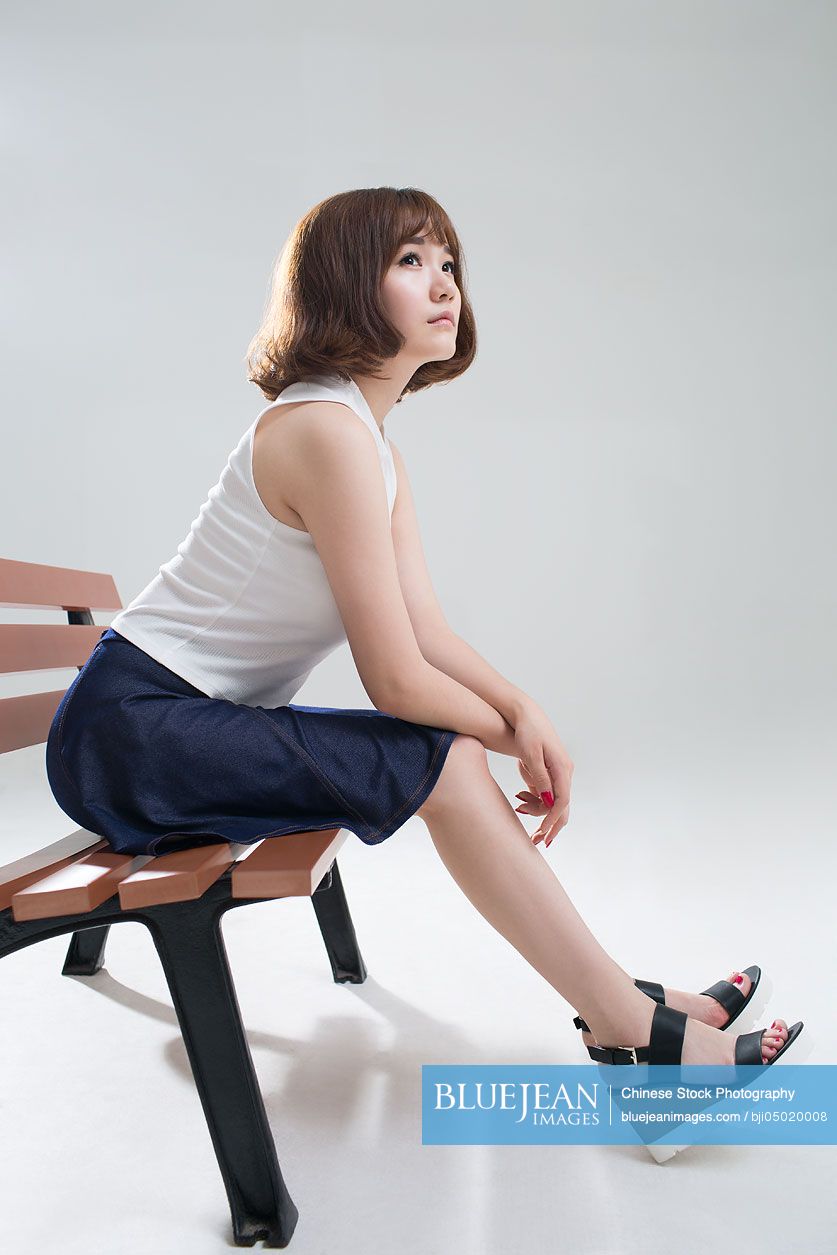 Young Chinese woman thinking