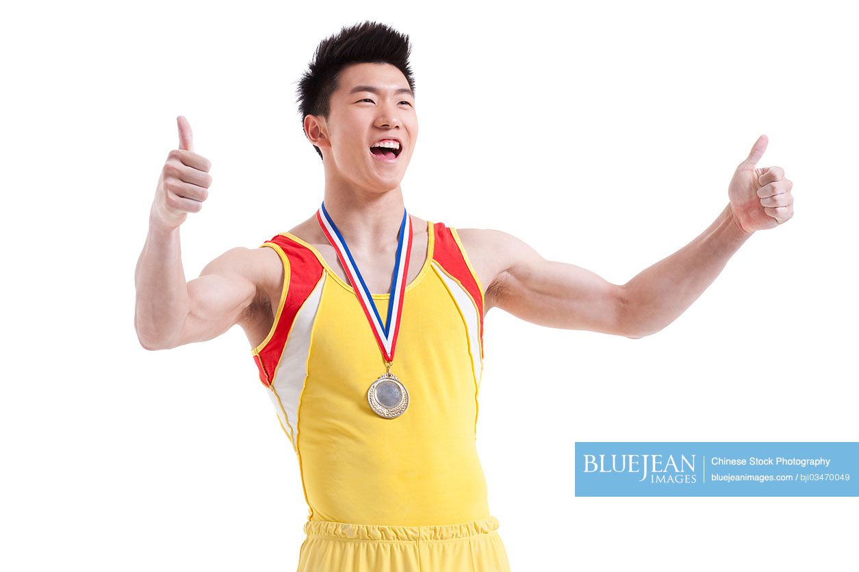 Chinese athlete with a medal doing thumbs up