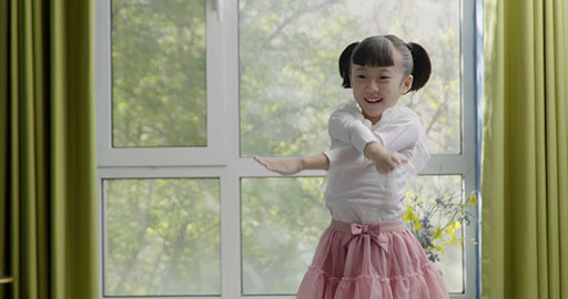 Little girl dancing casually at home