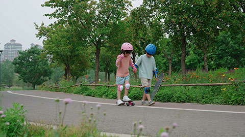 Happy kids skateboarding in the park