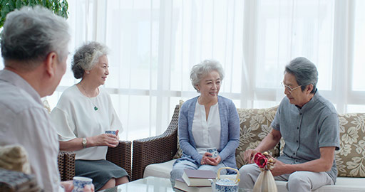 Happy senior Chinese friends drinking tea in living room,4K