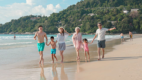 Happy Chinese family having fun on beach,4K