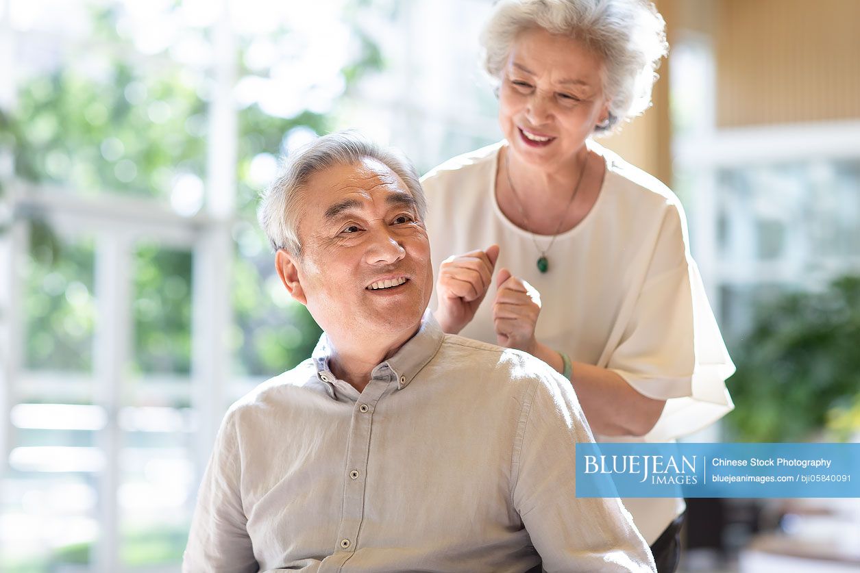 Senior Chinese wife taking care of her husband in nursing homeHighres