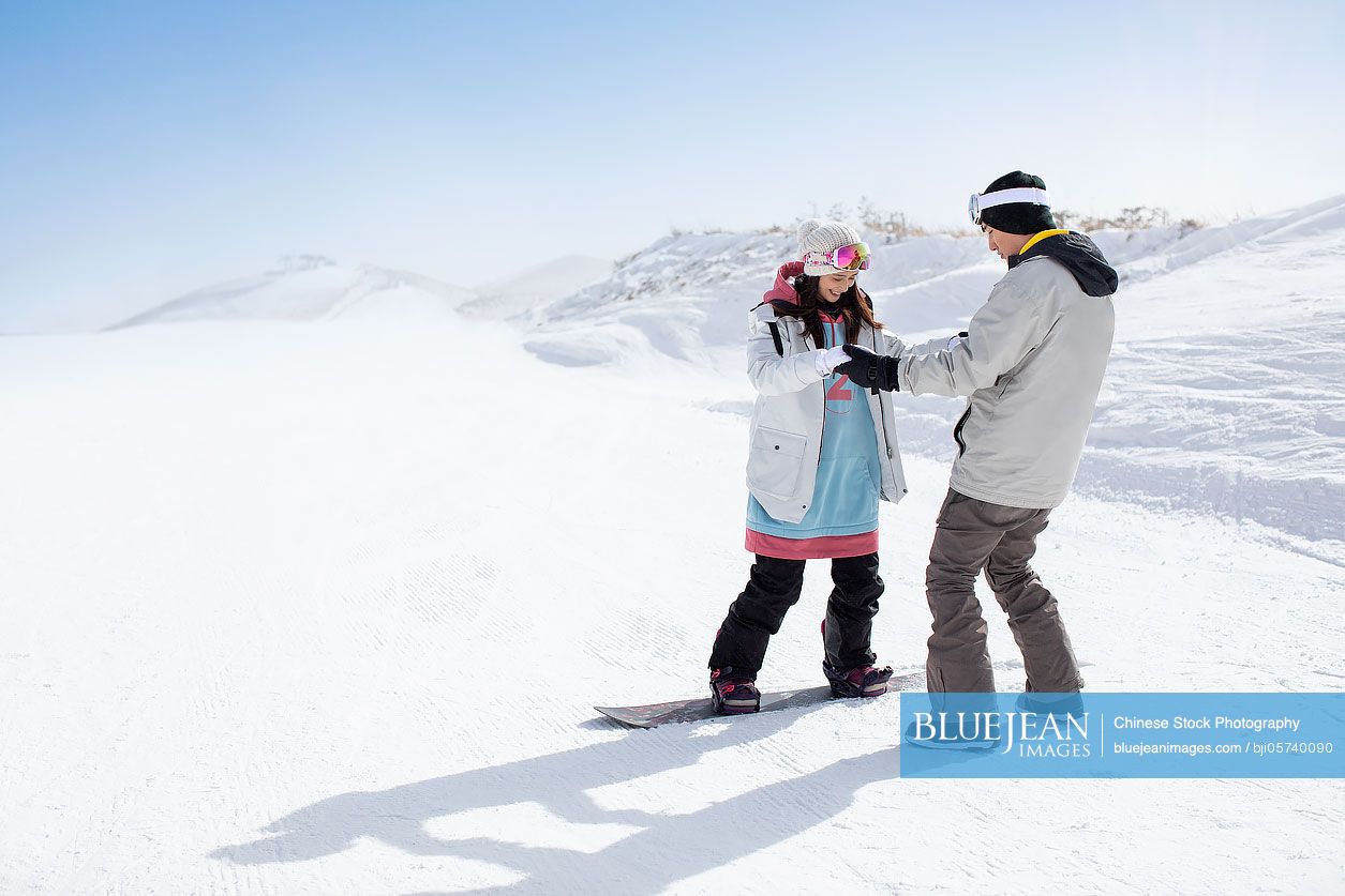 Happy young couple skiing in ski resort