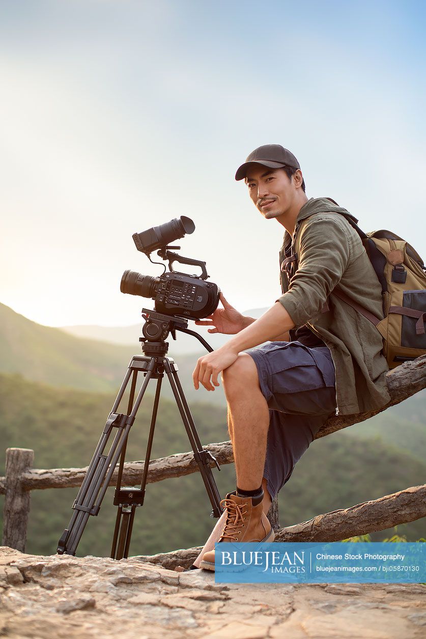 Chinese photographer taking photos outdoors