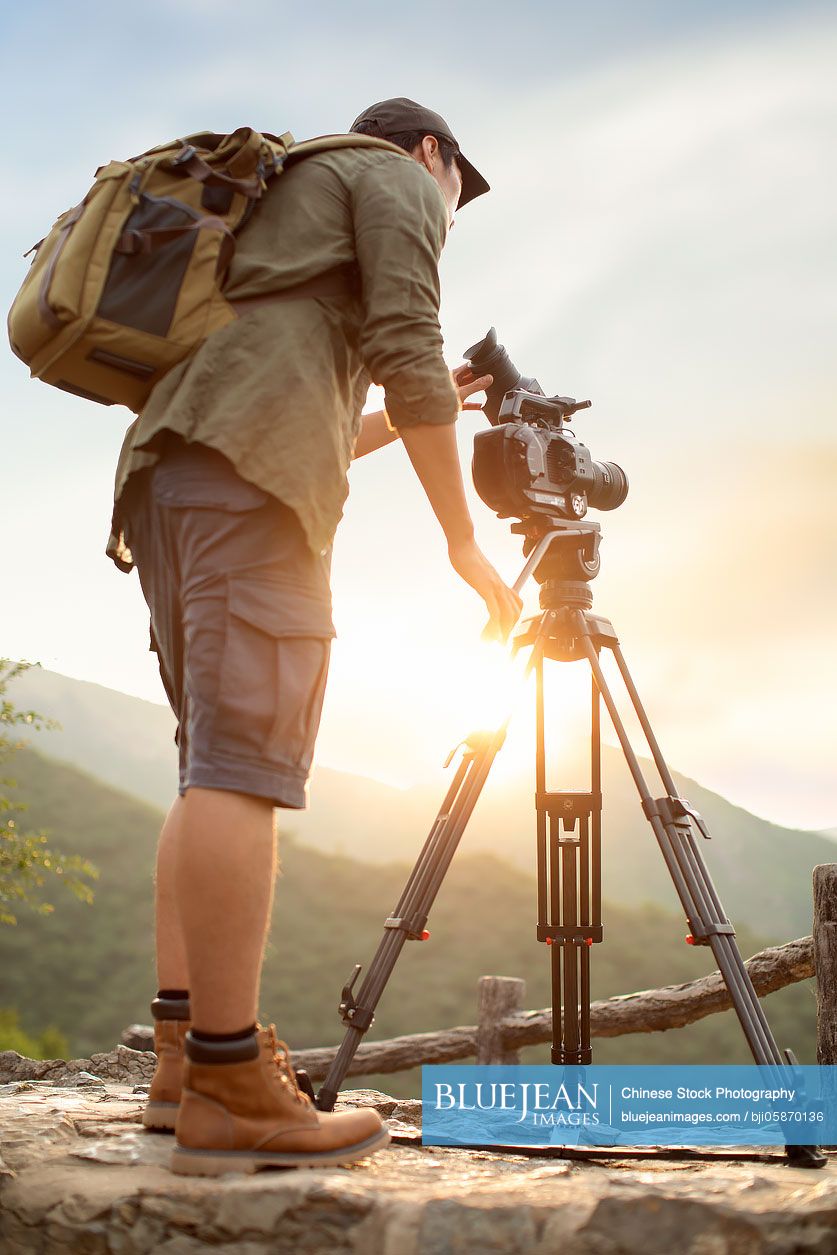 Chinese photographer taking photos outdoors