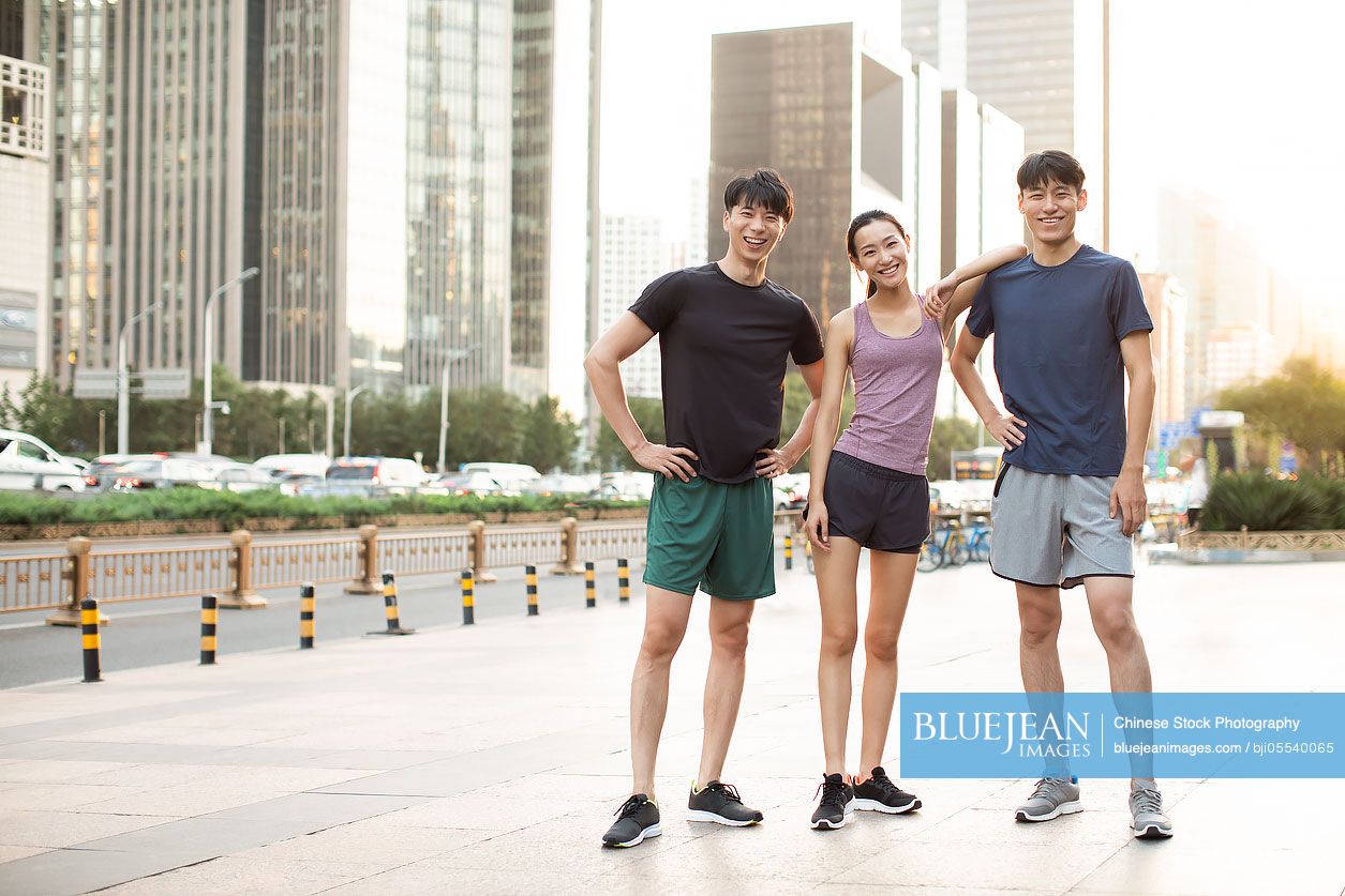 Young Chinese friends resting after exercising