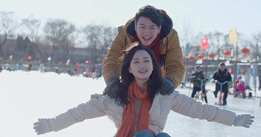 Happy young Chinese couple playing on ice,4K