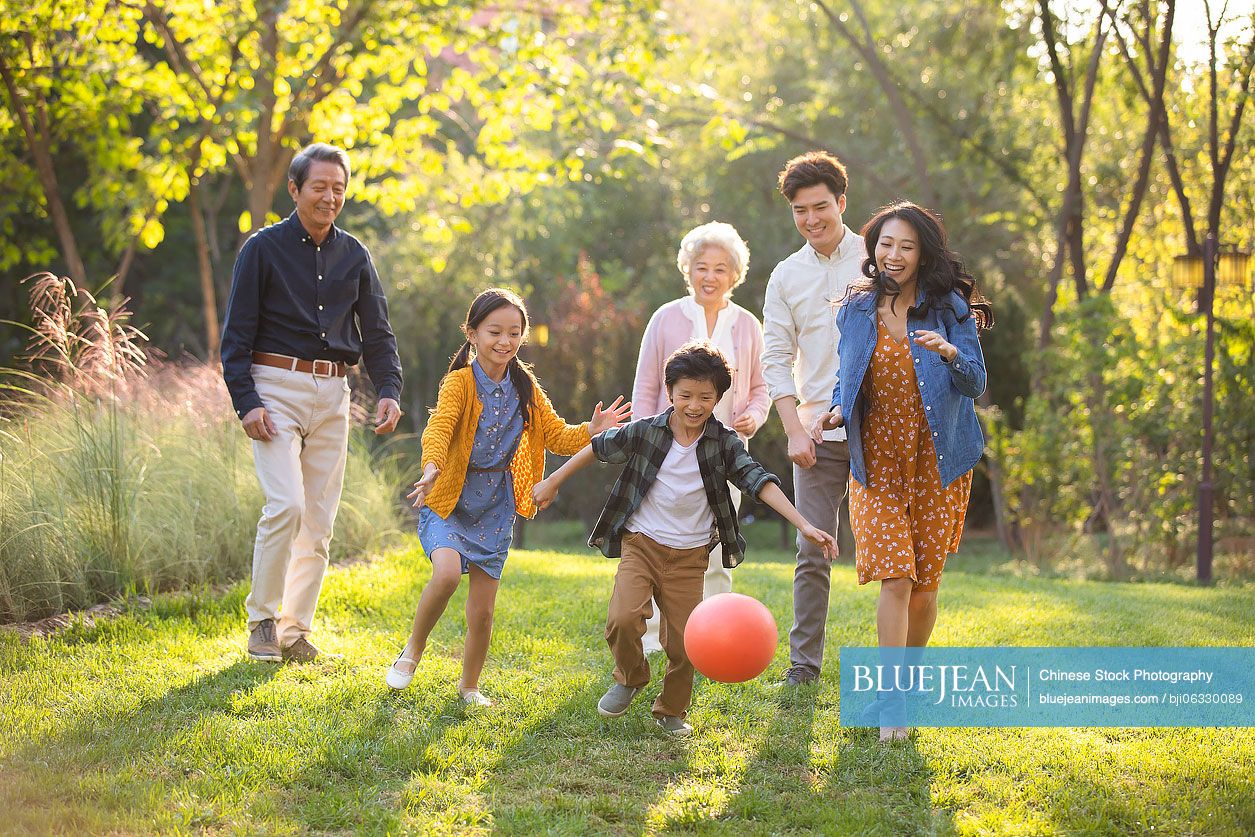 Happy Chinese family having fun in park