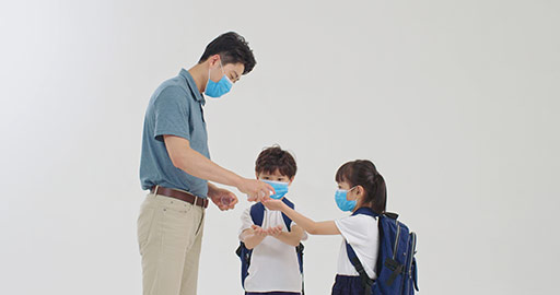 Chinese pupils using hand sanitizer with teacher's help,4K