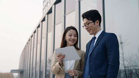 Confident Chinese business people talking outdoors