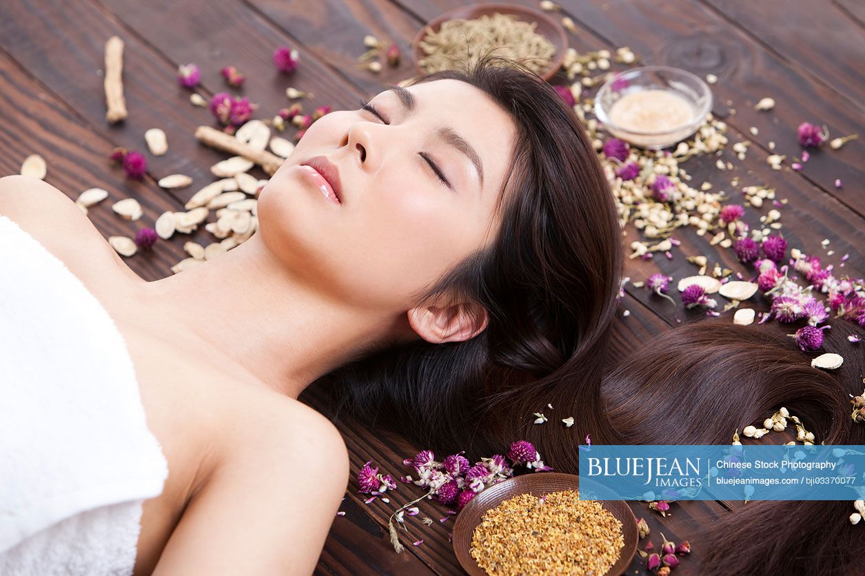 Beautiful young Chinese woman with herbal beauty treatment