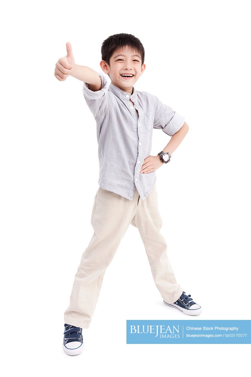 Portrait of cute Chinese boy doing thumbs up