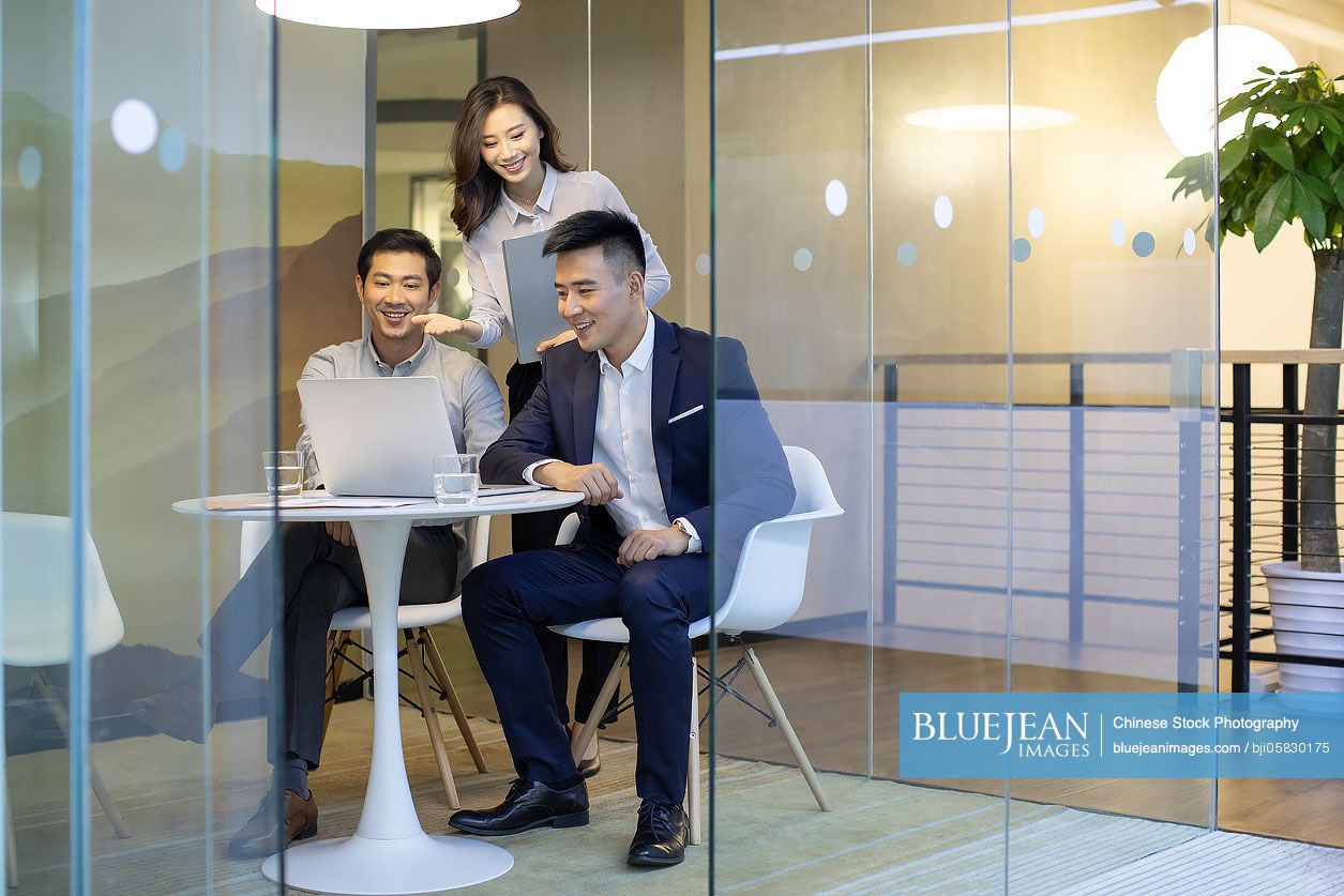 Confident Chinese business people talking in the office