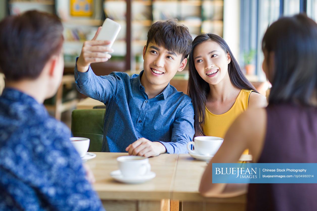 Young Chinese couple taking self portrait with a smart phone