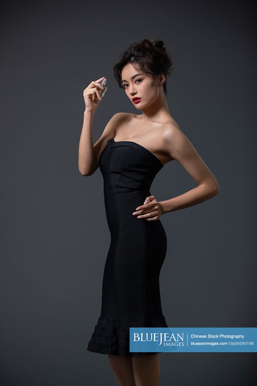 Beautiful young Chinese woman with perfume