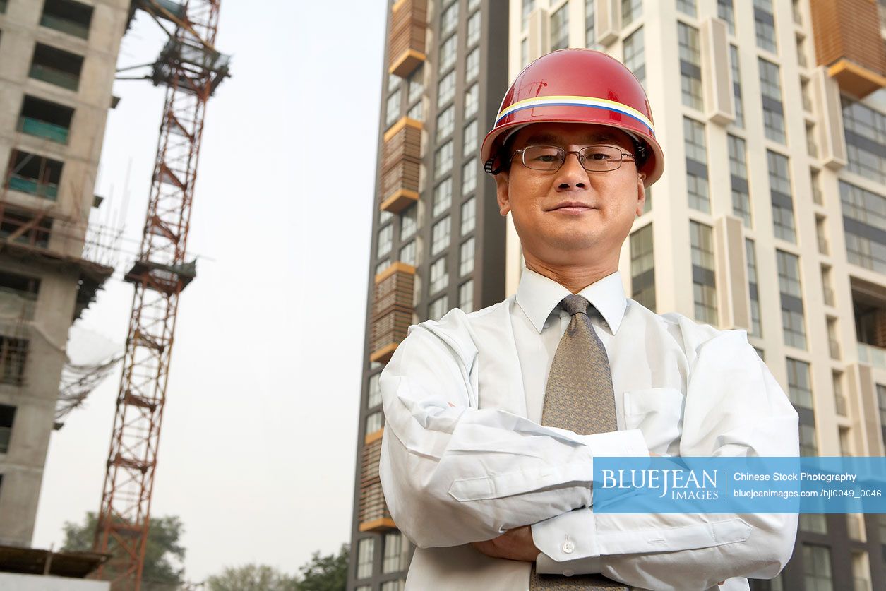 Chinese Construction Contractor Standing On Building Site