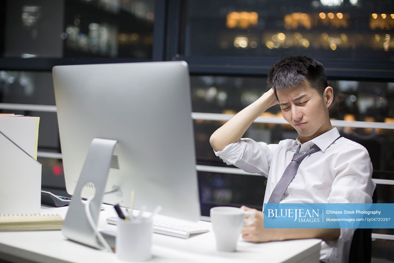 Chinese businessman working late in office