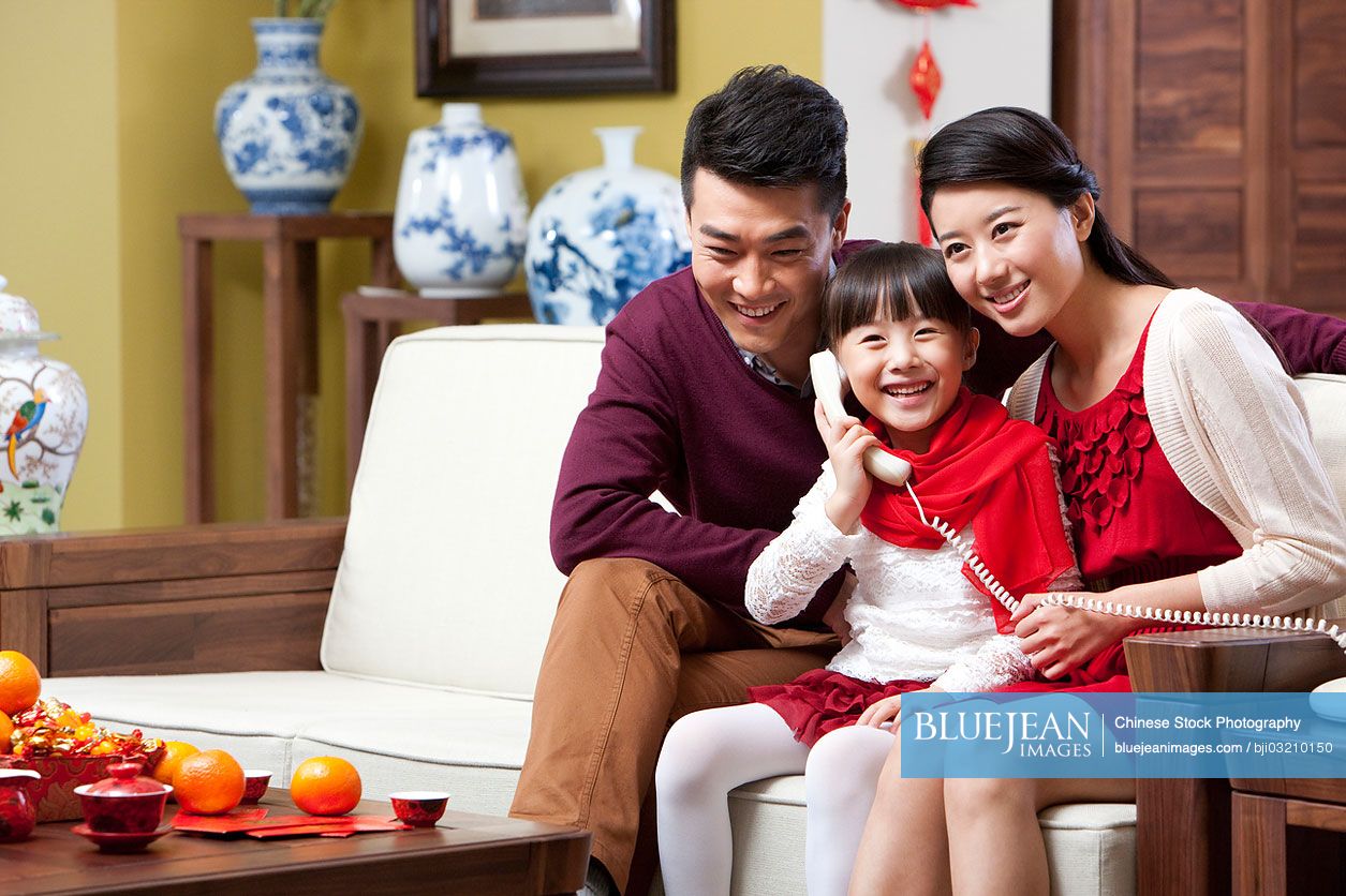 Young family on the phone during Chinese New Year