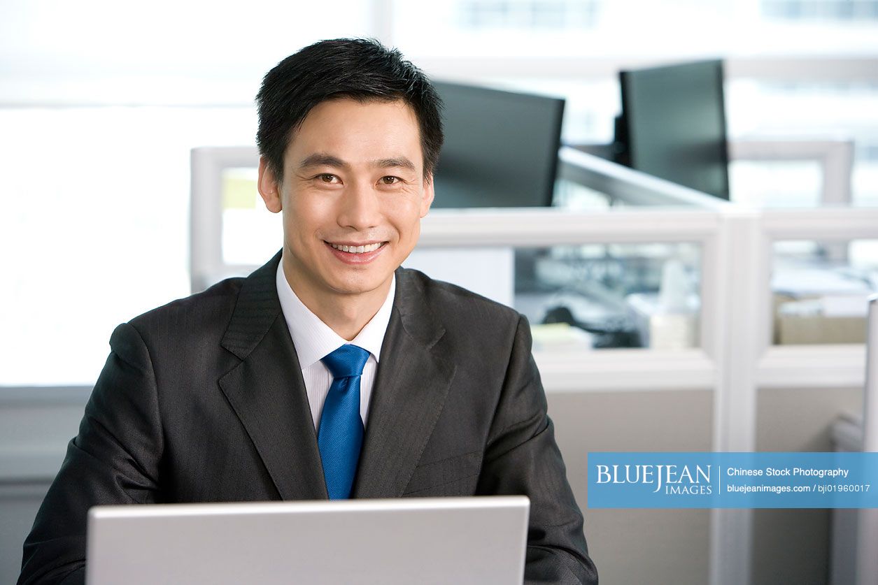 Chinese office worker at his desk