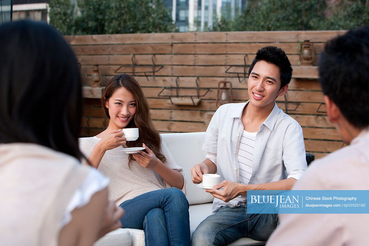 Chinese friends relaxing at an outdoor bar