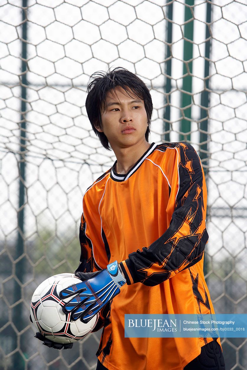 Chinese Goalkeeper Holding Soccer Ball