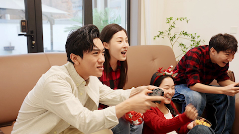 Friends playing a handheld video game together