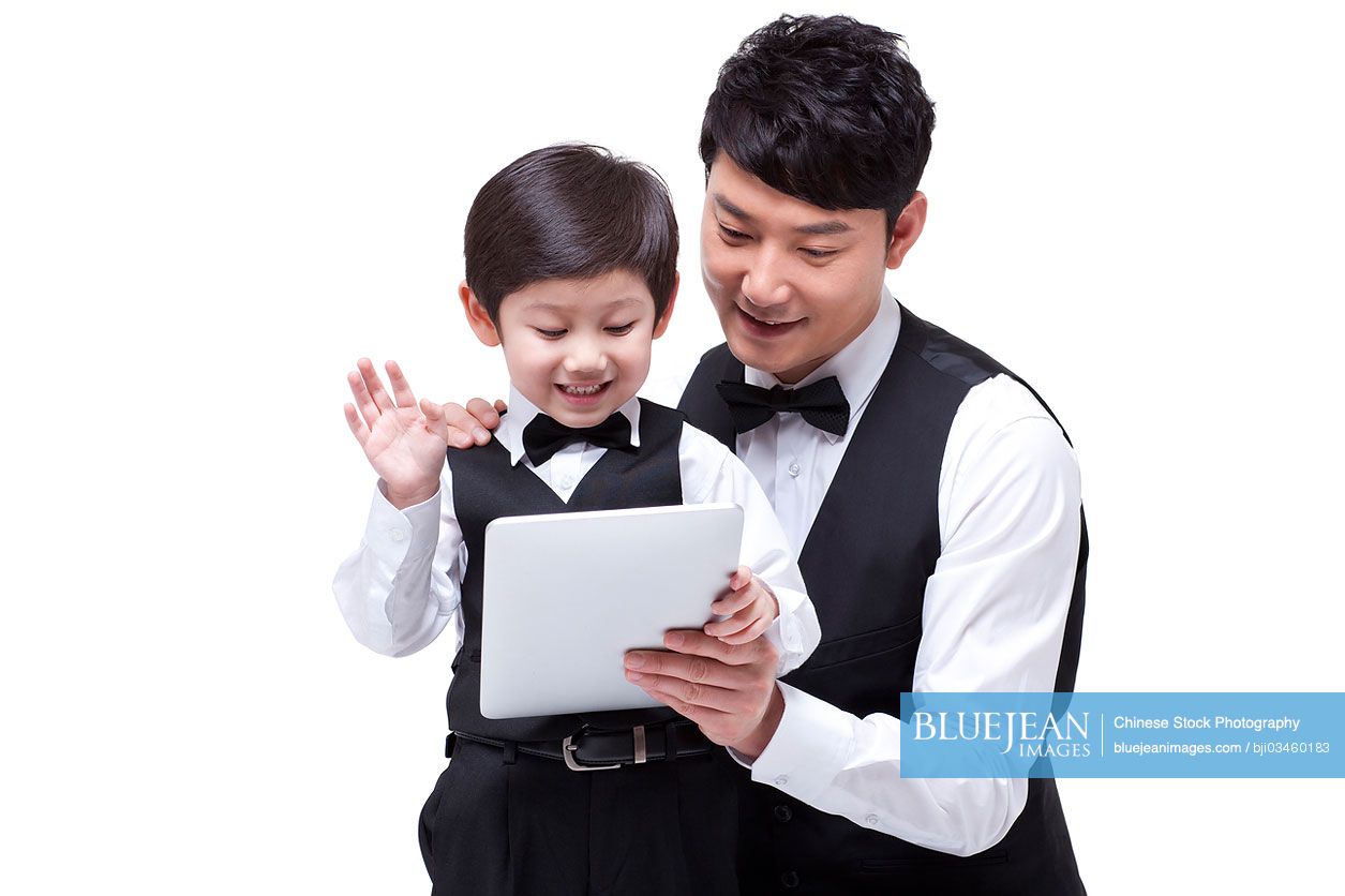 Young Chinese family with digital tablet