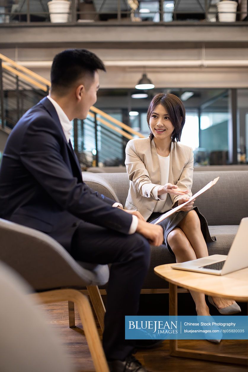 Young Chinese business people talking in office 