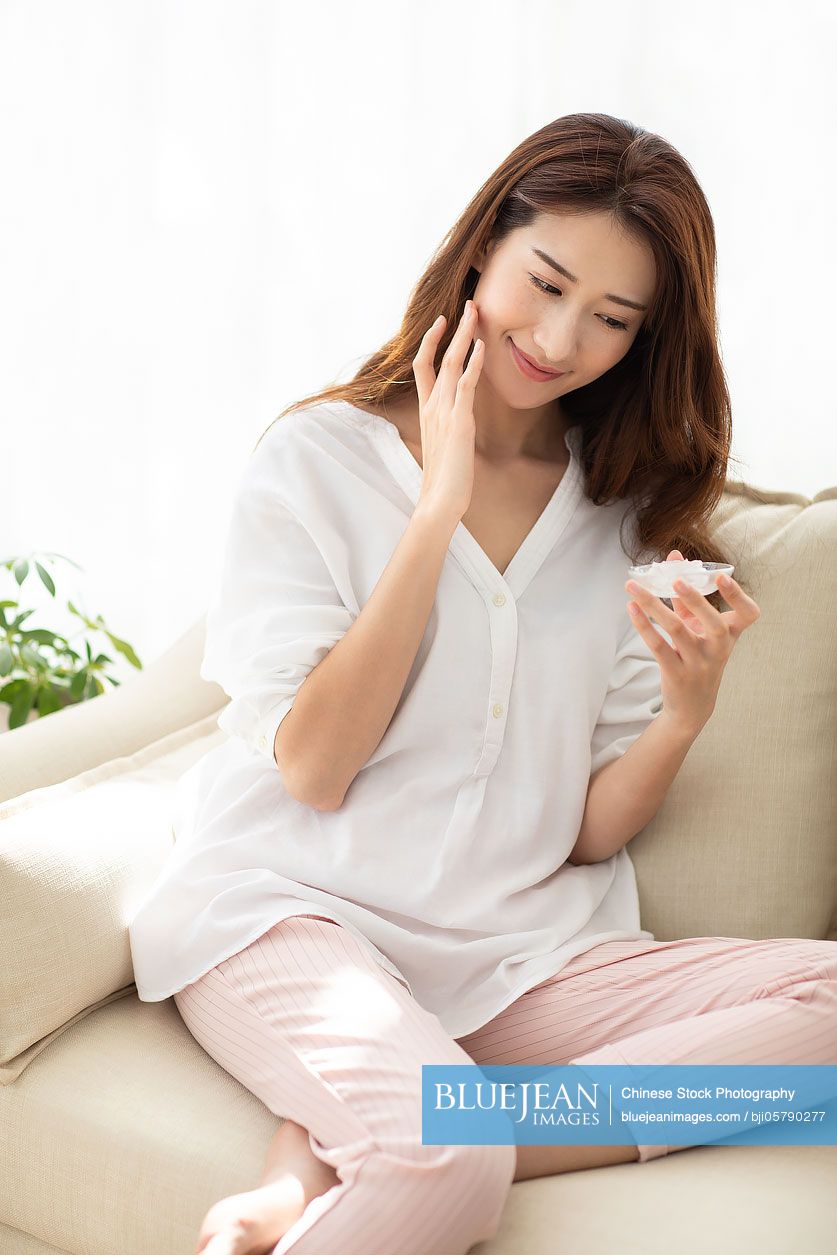 Young Chinese woman with natural aloe vera at home
