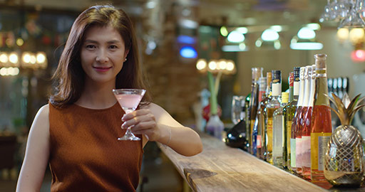 Beautiful Chinese woman drinking cocktail in bar,4K