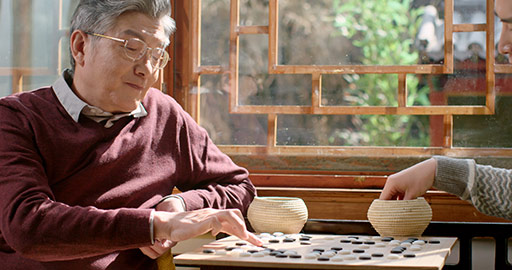 Happy Chinese father and son playing the game of go,4K