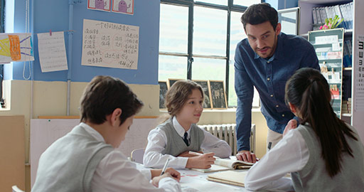 Young foreign teacher helping students in class,4K