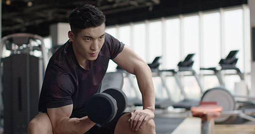 Young Chinese man working out with dumbbell at gym,4K